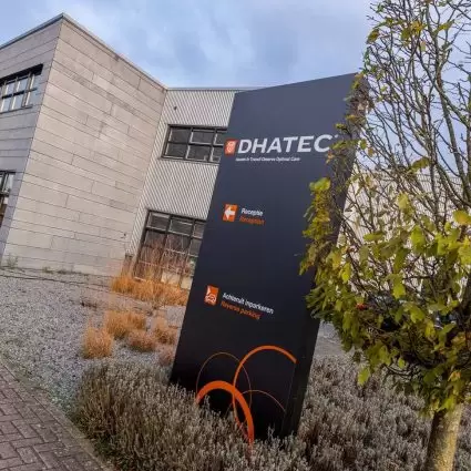 Image of the new Dhatec logo on the sign in front of the main Dhatec building.